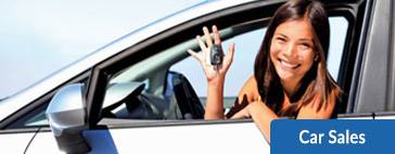 Woman holding car keys in new car