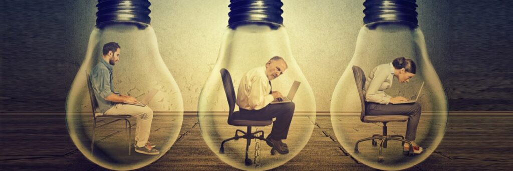 office workers sat with lightbulbs