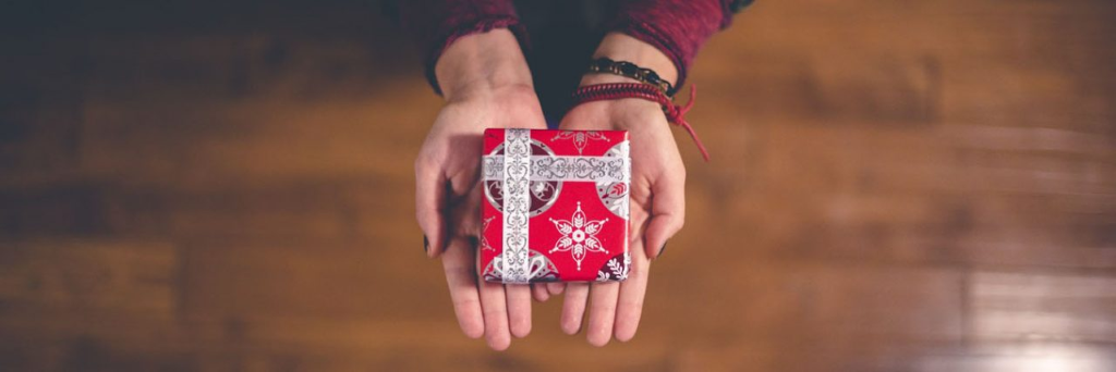 woman holding red christmas gift box